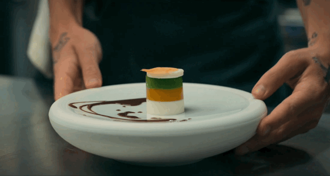 tri color desert (white, caramel, green) on a white plate with chocolate sauce