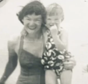 woman with dark hair with child both wearing bathing suits